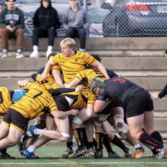 Alumni and current players in a maul