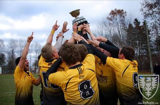 Dal Rugby players celebrating with a trophy